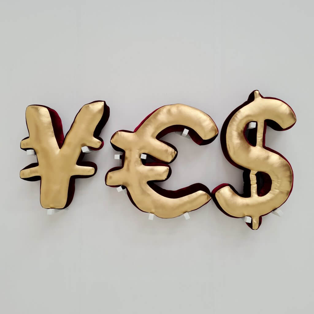 Stuffed toys in the shape of a ¥, € and $ currency symbol, together creating the word 'YES'. Black and red velvet, spandex, stuffing material, aluminum stands. 180x80x20cm, 2021